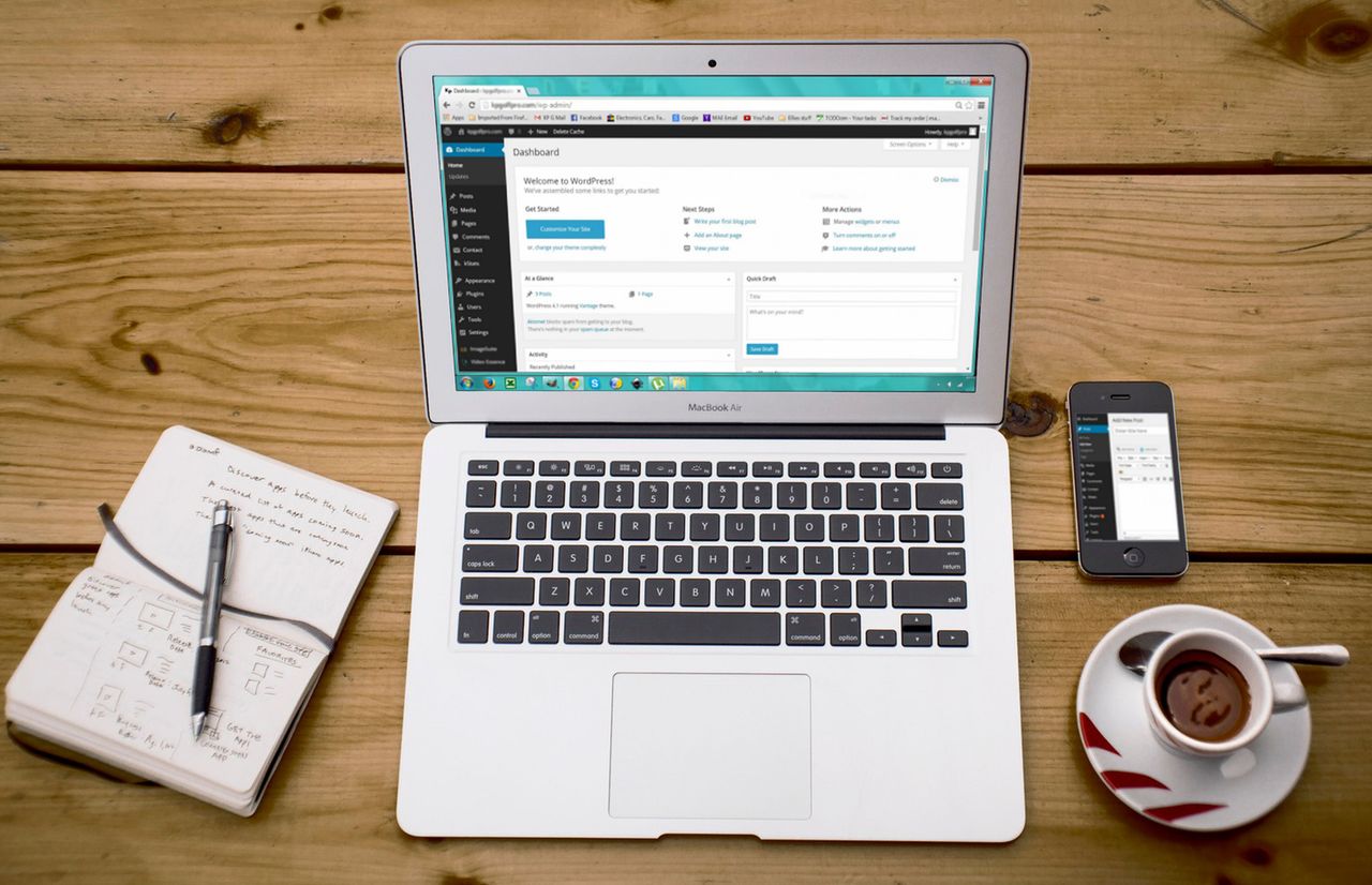 Services A cozy home office scene with a laptop, notebook, smartphone, and coffee, perfect for productivity.