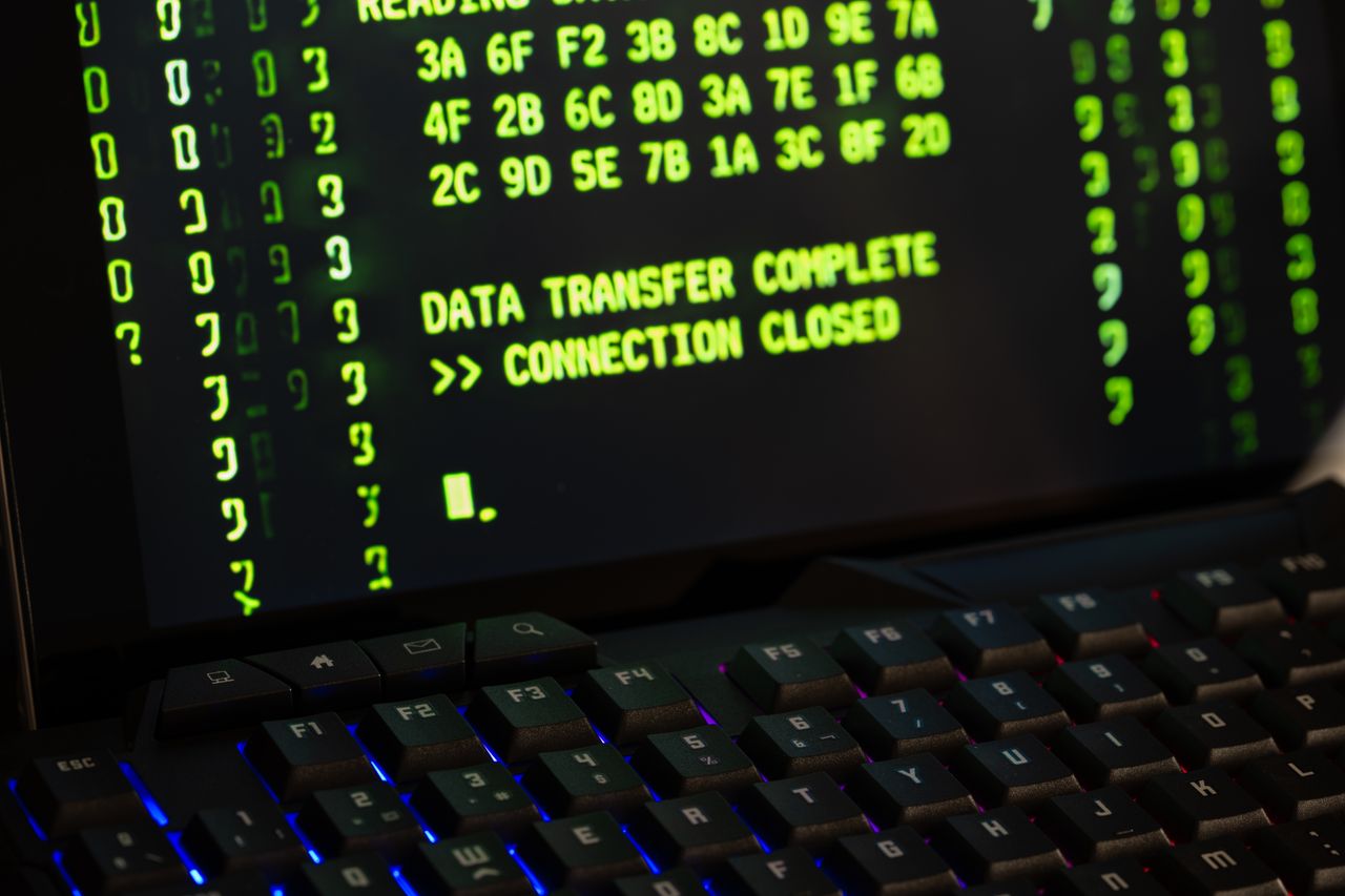 Data transfer complete message displayed on a computer monitor with a keyboard underneath.